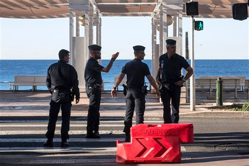 Riot police officers patrol on the Promenade des