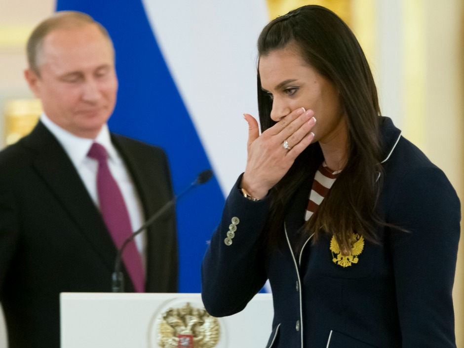 Russian pole-vaulter and Olympic champion Yelena Isinbayeva wipes away tears after speaking to fellow athletes at the Kremlin Wednesday