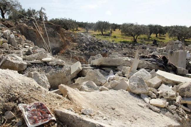 Belongings lie amid a damaged house which activists said belonged to Nusra Front and was destroyed by an apparent Syrian army air strike