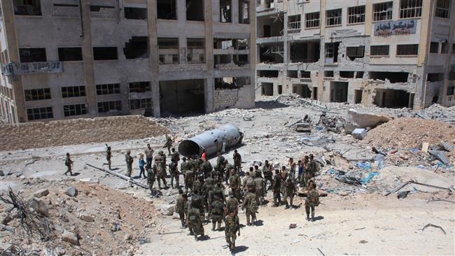 Syrian army soldiers patrol the area around the entrance of Bani Zeid after taking control of the previously terrorist-held district of Leramun on the northwest outskirts of Aleppo