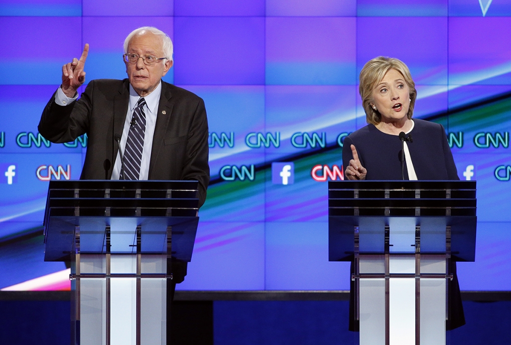 Hillary Rodham Clinton right and Sen. Bernie Sanders of Vermont speak during the CNN Democratic presidential debate Tuesday Oct. 13 2015 in Las Vegas