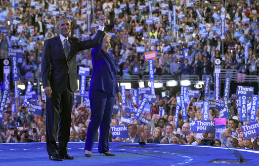 President Barack Obama right and Democratic presidential candidate Hillary Clinton left wave to the crowd following Obama's speech at the Democratic National Convention in Philadelphia Wednesday