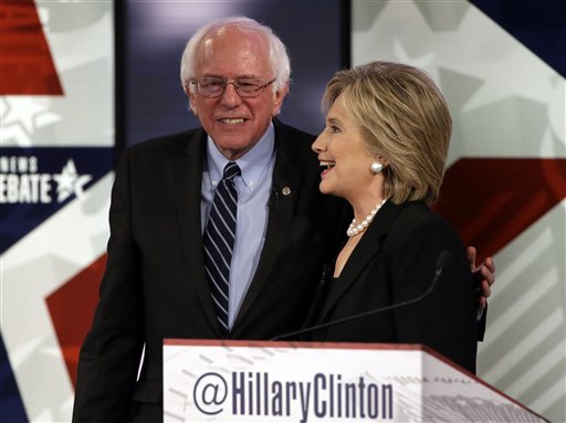 Hillary Rodham Clinton right talks to Bernie Sanders after a Democratic presidential primary debate Saturday Nov. 14 2015 in Des Moines Iowa