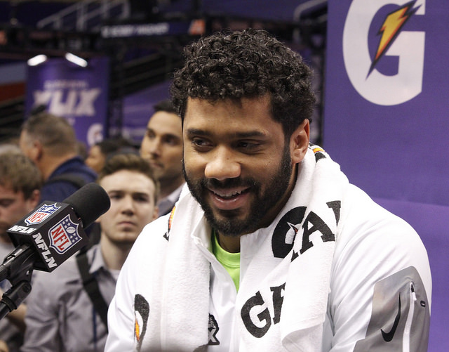 Seattle Quarterback Russell Wilson addresses the media before Super Bowl XLIX Jonathan Satriale WEBN TV Flickr CC