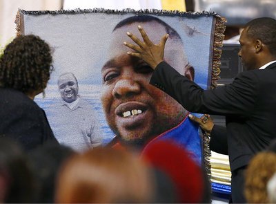 Mourners pay their respects as they attend the funeral of Alton Sterling in Baton Rouge Louisiana