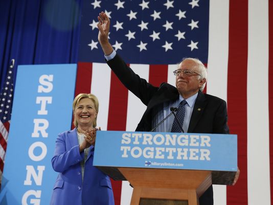 Sen. Bernie Sanders I-Vt. waves as he and Hillary Clinton arrive for a rally in Portsmouth N.H