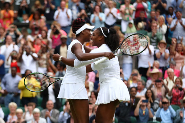 LONDON ENGLAND- JULY 09 Venus Williams of The United States and Serena Williams of The United States celebrate victory in the Ladies Doubles Final against Timea Babos of Hungary and Yaroslava Shvedova of Kazakhstan on day twelve of the Wimbledon Lawn T