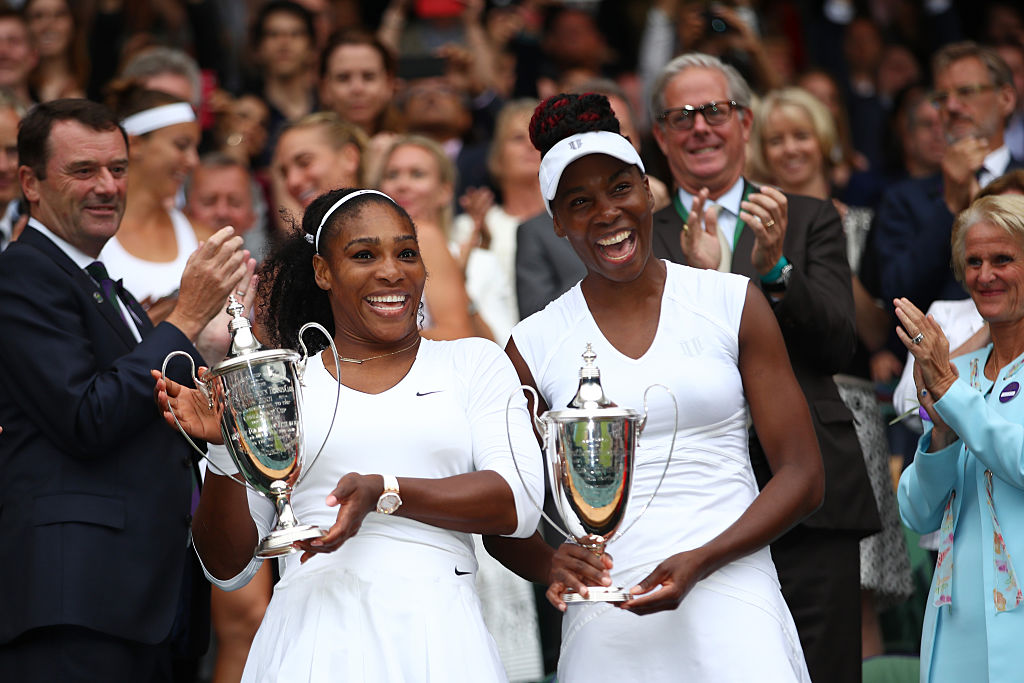 LONDON ENGLAND- JULY 09 Venus Williams of The United States and Serena Williams of The United States celebrate victory in the Ladies Doubles Final against Timea Babos of Hungary and Yaroslava Shvedova of Kazakhstan on day twelve of the Wimbledon Lawn T