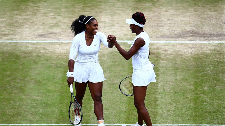 Serena and Venus Williams celebrate victory in the semi-finals