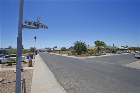 Near this block of West Berkeley Road in the Maryvale section of Phoenix three persons died in one of a rash of shootings shown here during the day Friday