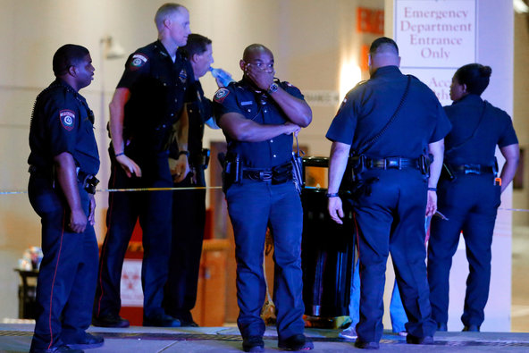 Dallas police officers outside the emergency room at Baylor University Medical Center on Friday. Snipers opened fire on officers in the heart of Dallas on Thursday night killing at least five