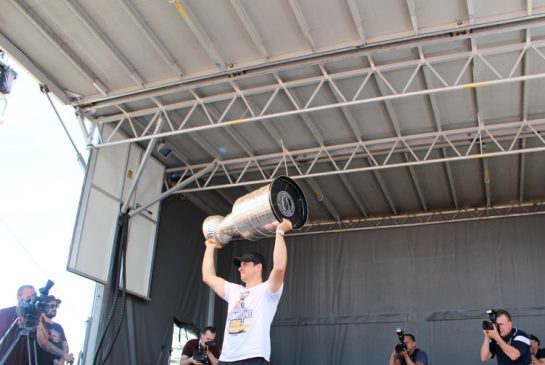 Pittsburgh Penguins captain Sidney Crosby hoists the Stanley Cup as tens of thousands of hometown fans cheer him on Saturday at Cole Harbour Place