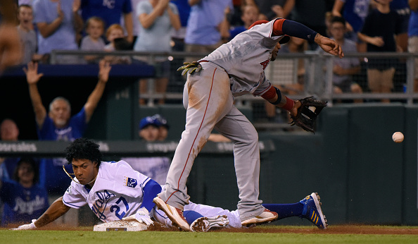 KANSAS CITY MO- JULY 27 Raul Mondesi #27 of the Kansas City Royals slides safely into third past Yunel Escobar #6 of the Los Angeles Angels of Anaheim in the seventh inning at Kauffman Stadium