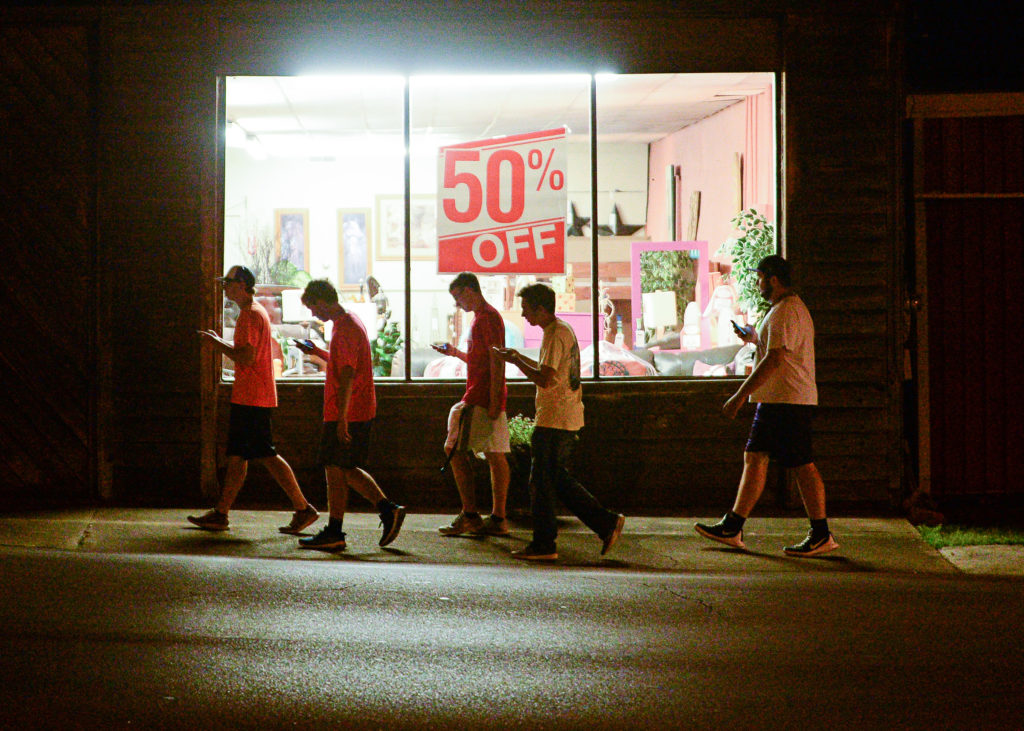 Slide 1  of 1		.		
		
			Caption
			A group of teenagers play'Pokemon Go in downtown Hartselle