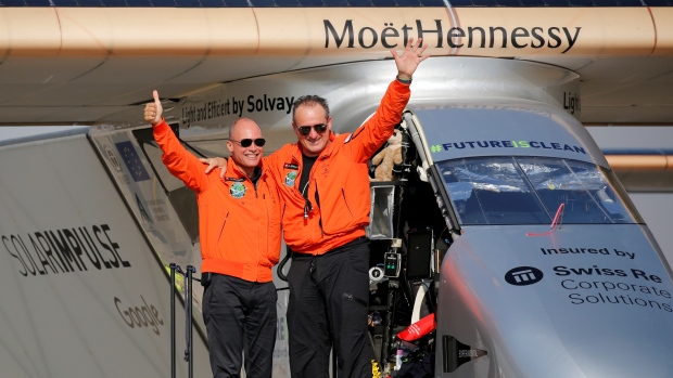 Andre Borschberg right the Swiss pilot of Solar Impulse 2 a solar powered plane is greeted by fellow pilot and countryman Bertrand Piccard after landing at Cairo Airport after another leg of their globe-circling voyage