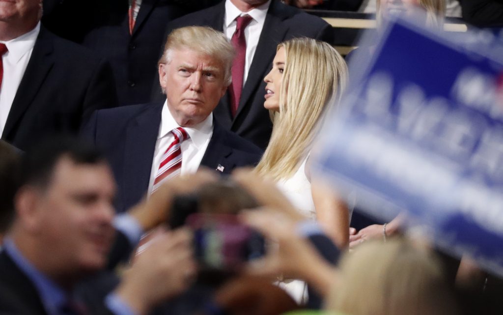 Republican presidential nominee Donald Trump talks to his daughter Ivanka in the Trump family box at the conclusion of former rival candidate Sen. Ted Cruz's address during the third night of the Republican National Convention in Cleveland Ohio on J