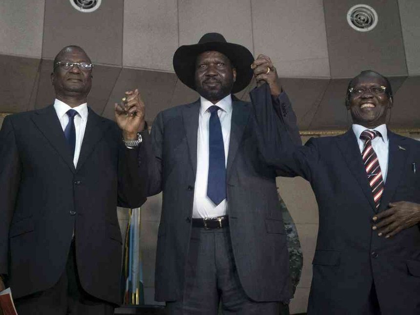 South Sudan's President Salva Kiir holds hands with First Vice President Taban Deng Gai and Second Vice President James Wani Igga inside the Presidential Palace in the capital of Juba South Sudan