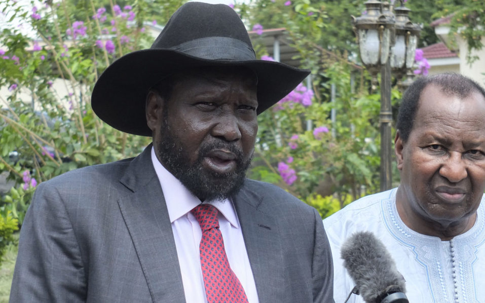 South Sudanese President Salva Kiir, flanked by African Union special envoy and former Malian President Alpha Oumar Konare, talks to the media