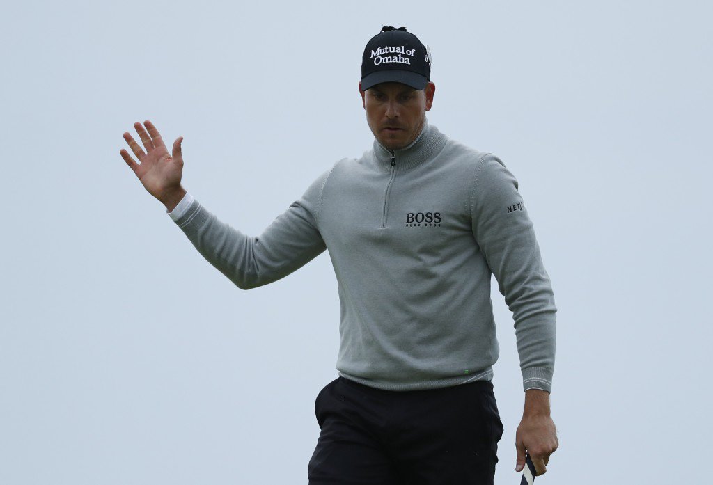 Henrik Stenson of Sweden acknowledges the crowd after putting and making a birdie on the 17th green during the third round of the British Open Golf Championship at the Royal Troon Golf Club in Troon Scotland Saturday