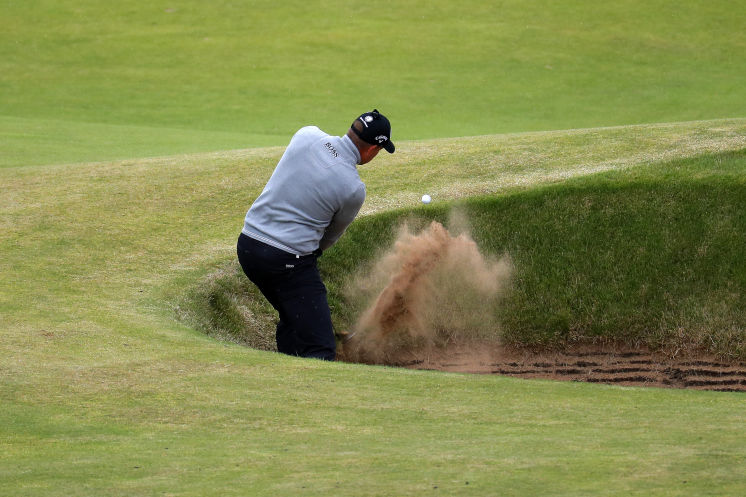 Henrik Stenson playing out of a bunker on No. 7 shoots his third straight round in the 60s to lead Phil Mickelson by one shot. Stenson 40 has never won a major championship