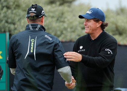 Henrik Stenson of Sweden left is greeted by Phil Mickelson of the United States on the first tee prior to the start of their third round of the British Open Golf Championship at the Royal Troon Golf Club in Troon Scotland Saturday