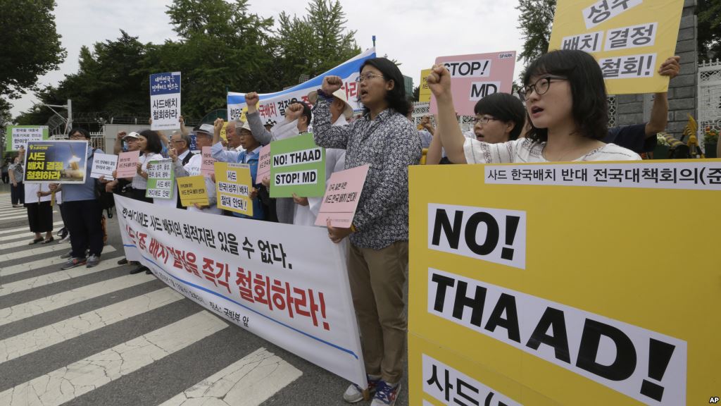 Protesters shout slogans during a rally to denounce deploying the Terminal High Altitude Area Defense or THAAD in front of the Defense Ministry in Seoul South Korea Wednesday