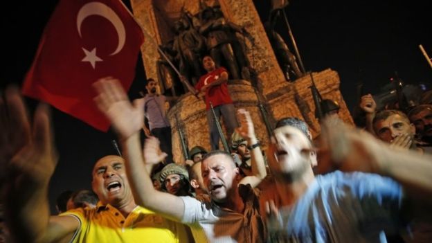 Supporters of President Erdogan hold his portrait aloft as they celebrate the quashing of a coup attempt in Ankara