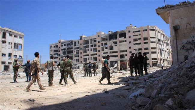 Syrian army soldiers patrol the area around the entrance of Aleppo’s Bani Zeid district