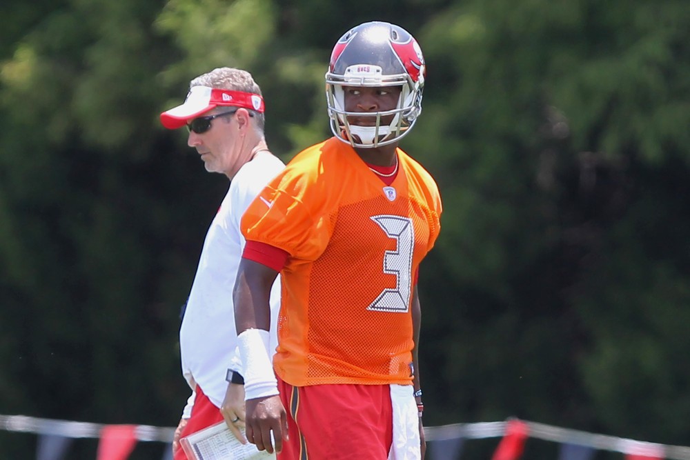 14 JUN 2016 Head Coach Dirk Koetter passes by behind Jameis Winston during the Tampa Bay Buccaneers Mini Camp at One Buccaneer Place in Tampa Florida