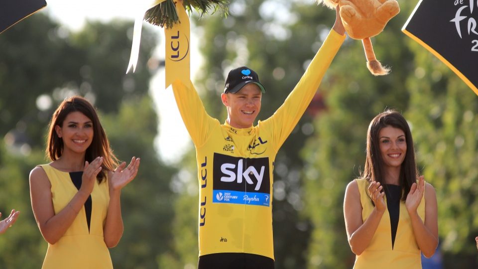 Team Sky's Chris Froome celebrates as he collects the yellow jersey for winning the Tour De France