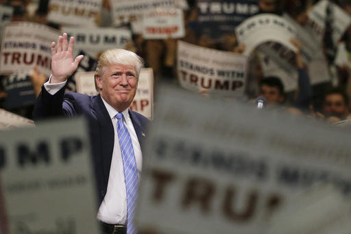 Republican presidential candidate Donald Trump waves to the crowd as he arrives at a rally at the Anaheim Convention Center