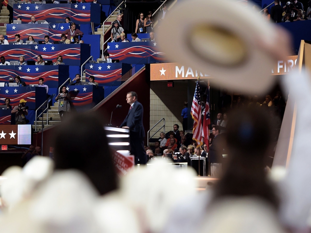 Delegates from Texas listen as Texas senator and former Republican presidential candidate Ted Cruz addresses Wednesday evening's session of the Republican National Convention in Cleveland