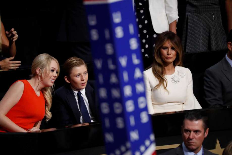 Barron Trump center son of Donald and Melania Trump talks to Tiffany Trump as Melania Trump sits at right during the final day of the Republican National Convention in Cleveland Thursday