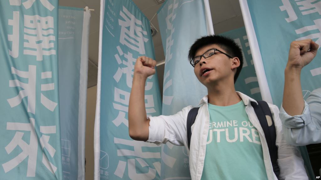 Teen protest leader Joshua Wong shouts slogans outside a magistrate's court in Hong Kong Thursday