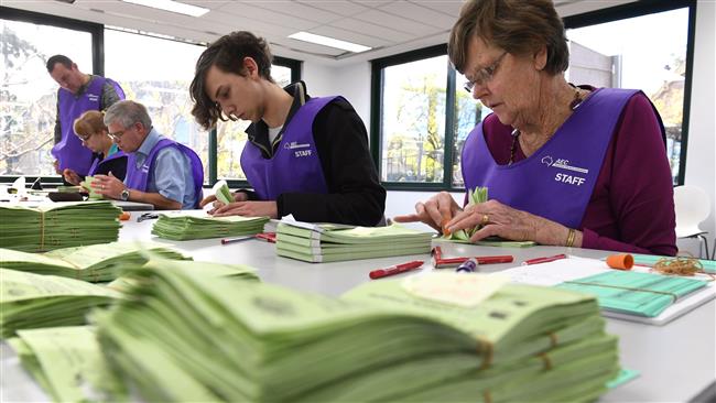 Temporary Australian Electoral Commission workers count votes in Sydney