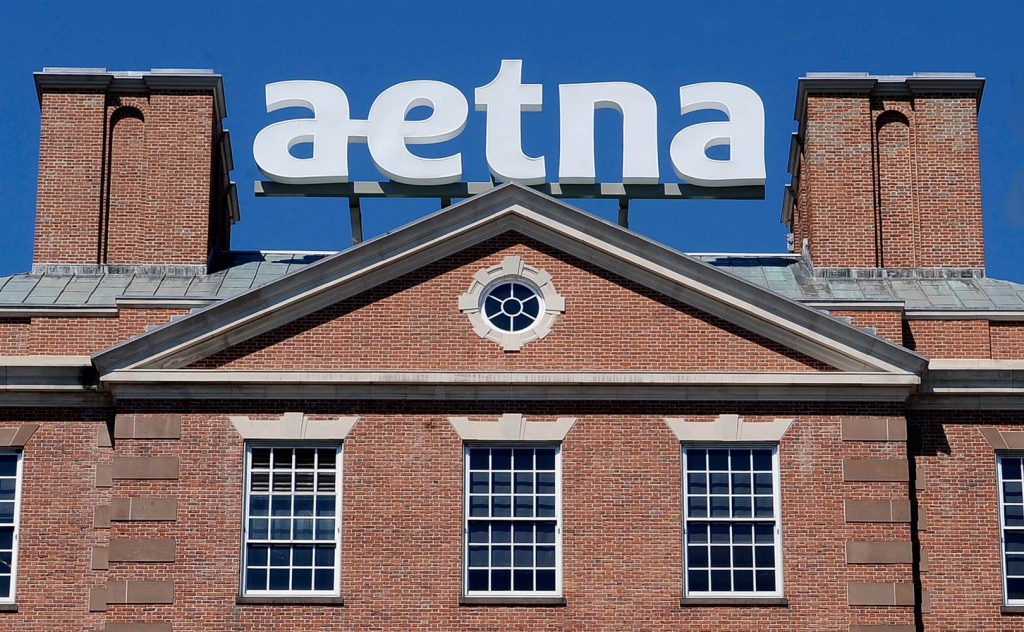 Image A sign for Aetna Inc. sits atop a building at the company headquarters in in Hartford Conn