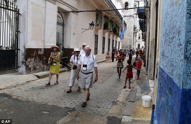 U.S. tourists walk outside the Bodeguita del Medio Bar in Old Havana Cuba. U.S. transport authorities nominated eight airlines to begin regularly scheduled services to Havana from 10 U.S. cities