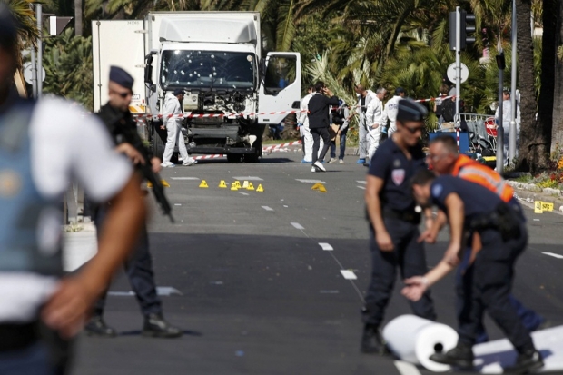 French police secure the area as the investigation continues at the scene near the heavy truck that ran into a crowd at high speed during the Bastille Day July 14 national holiday celebrations in Nice France