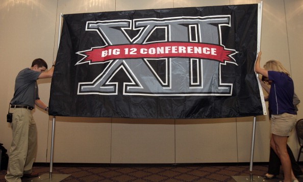 FORT WORTH TX- OCTOBER 10 Texas Christian University sophomore Zach Boring, and freshman Laura Dunn raise a Big XII Conference banner before a press conference in which TCU accepted an invention to join the Big XII