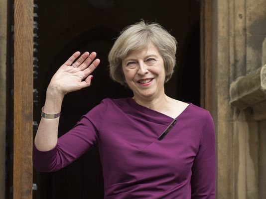 British Home Secretary Theresa May waves to members of the media outside of The Houses of Parliament in London Britain