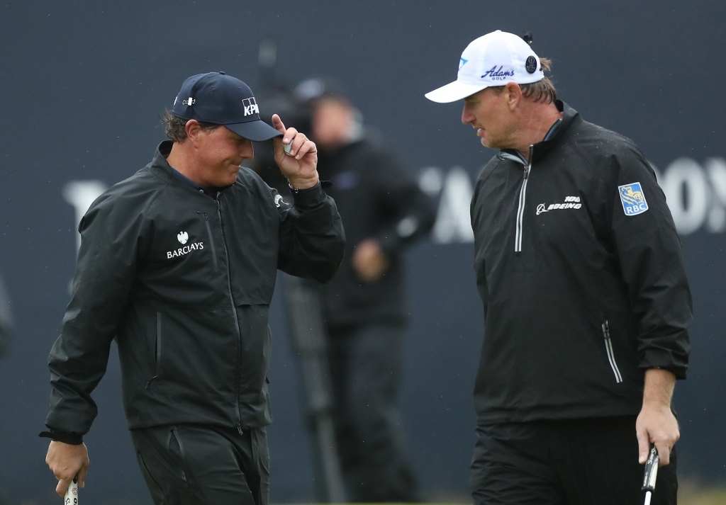 Phil Mickelson of the United States left smiles with Ernie Els of South Africa on the 18th green after he completes his second round of the British Open Golf Championship at the Royal Troon Golf Club in Troon Scotland Friday