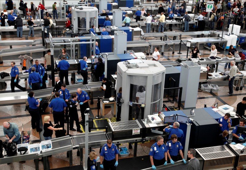 Transportation Security Agency workers carry out security checks at Denver International Airport