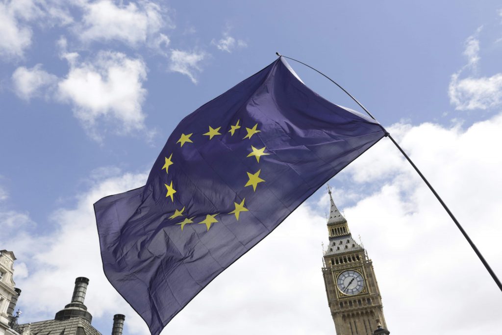 A European Union flag is held in front of the Big Ben clock tower in Parliament Square during a'March for Europe demonstration against Britain's decision to leave the European Union central London