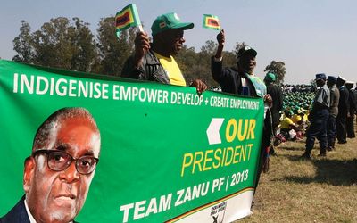 Supporters cheer Zimbabwean President Robert Mugabe at the launch of his ruling Zanu party's election manifesto in the capital Harare last month