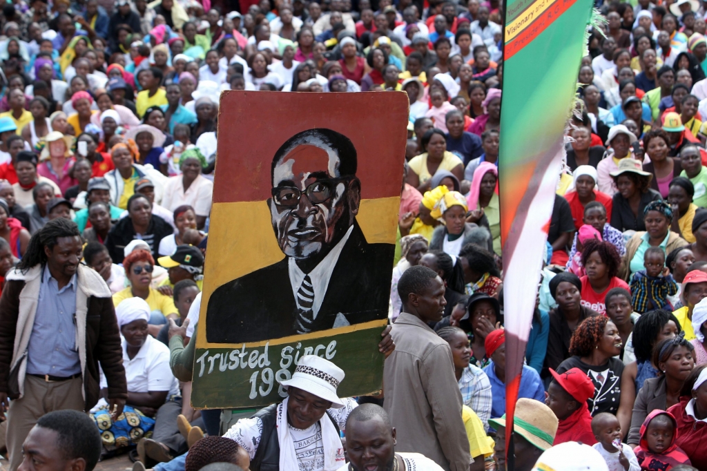 Defiant Robert Mugabe hits out at protesters as thousands march in support