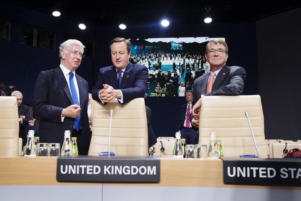 OBAMA NATO 3-100 Prime Minister David Cameron of Britain stands with his defense secretary Michael Fallon left and U.S. Defense Secretary Ash Carter on Saturday in Warsaw at a working session at the NATO summit