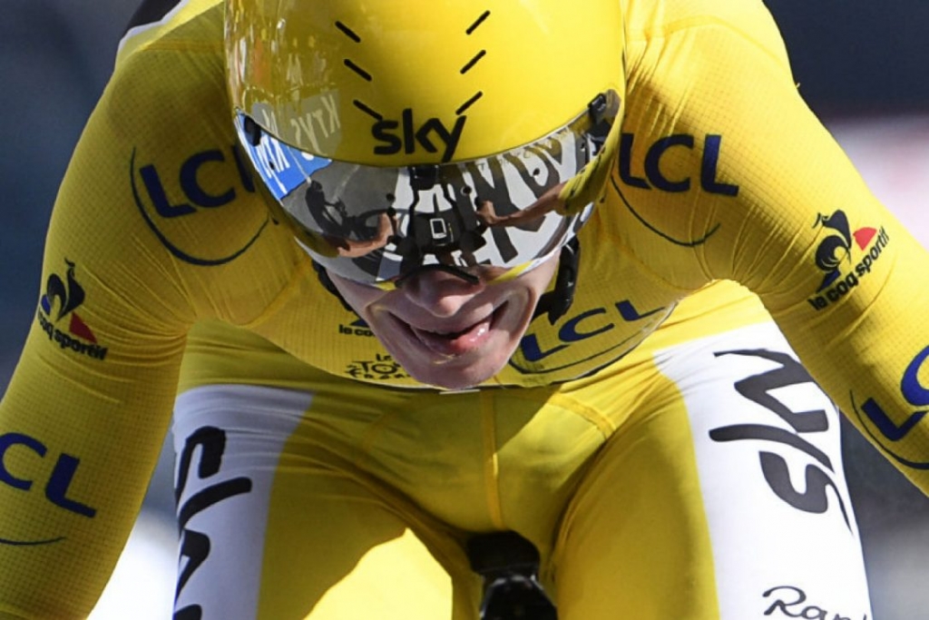 Britain's Christopher Froome wearing the overall leader's yellow jersey crosses the finish line at the end of the 17 km individual time-trial the eighteenth stage of the 103rd edition of the Tour de France cycling race