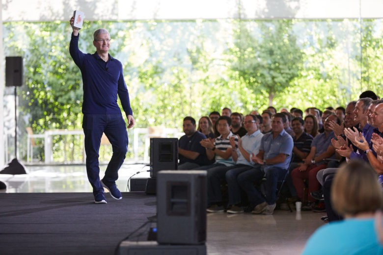 Tim Cook holds Apple's billionth iPhone