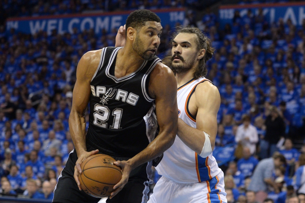 Oklahoma City OK USA San Antonio Spurs center Tim Duncan fights for position with Oklahoma City Thunder center Steven Adams during the first quarter in game six of the second round of the NBA Playoffs at Chesapeake Energy Arena