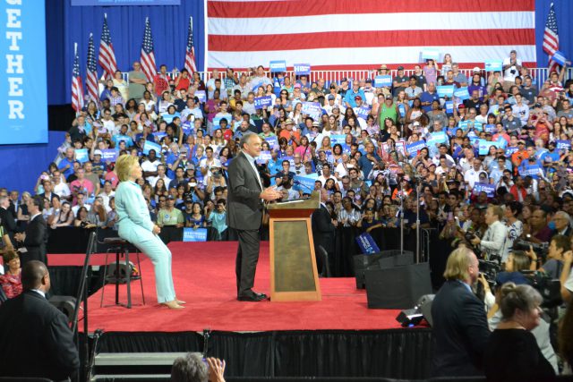 Tim Kaine speaking with Hillary Clinton at a rally after she chose him to be her running mate